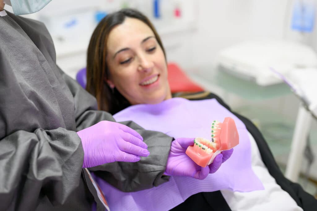 Orthodontist explaining braces treatment timeline to patient